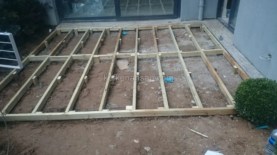 Timber deck substructure on soil in a garden, showing the points where the joists connect