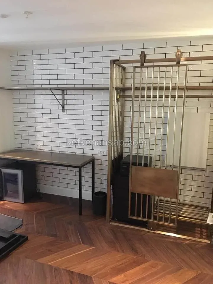 Beyaz metro fayans duvarlı odada balık sırtı ahşap parke, metal çerçeveli sürgülü panel, çalışma masası ve duvar rafı