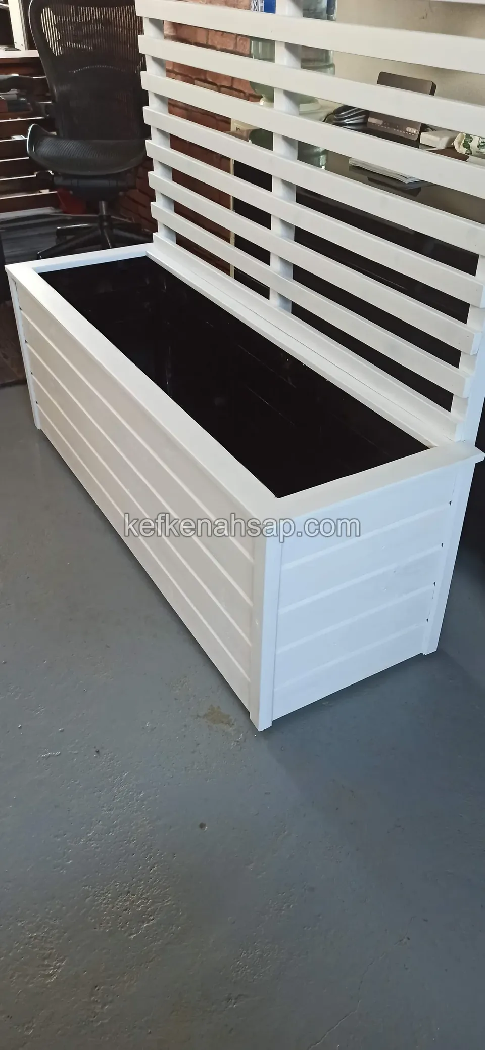 White-painted planter box with horizontal slats and a slatted back screen, black-lined inside
