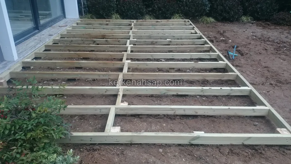 Wide timber deck substructure frame laid on soil, seen from above