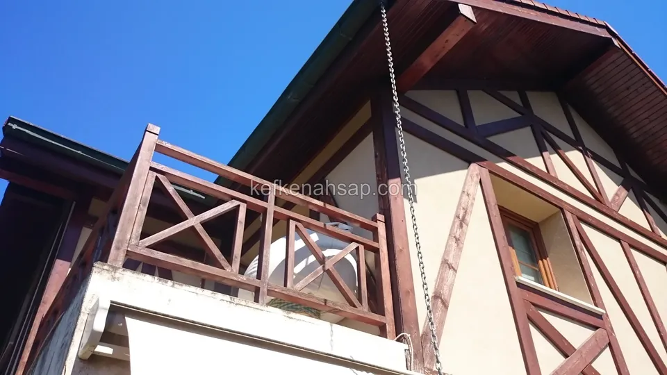 Cross-slat timber railing on the balcony of a half-timbered house