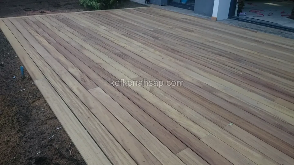 Close view of newly laid light-toned timber deck boards and the border board around the edge
